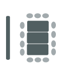 Three tables pushed together, chairs surrounding the tables, and a screen.