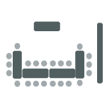 Four tables in a u-shape with chairs surrounding the tables.