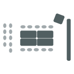 Four tables pushed together, chairs surrounding the tables, one podium, one screen, and two rows of chairs.