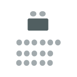 Rows of chairs facing one table and two chairs at the front.