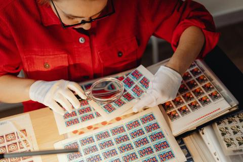 appraiser examining stamps