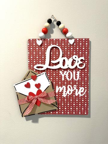 valentine wall plaque says "Love You More"