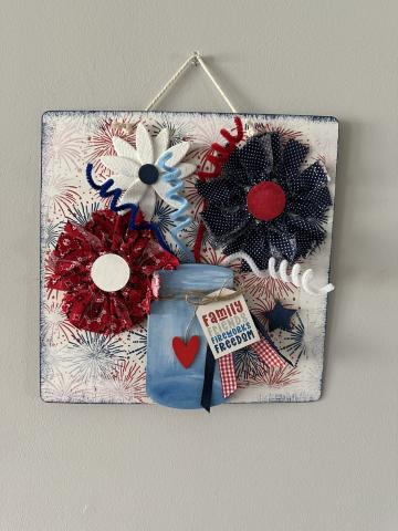 red white and blue flowers in a mason jar