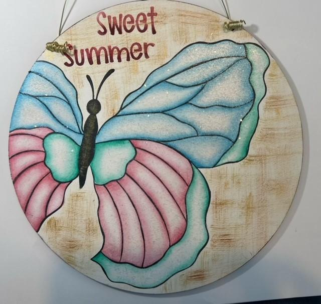 butterfly painted on wooden disc