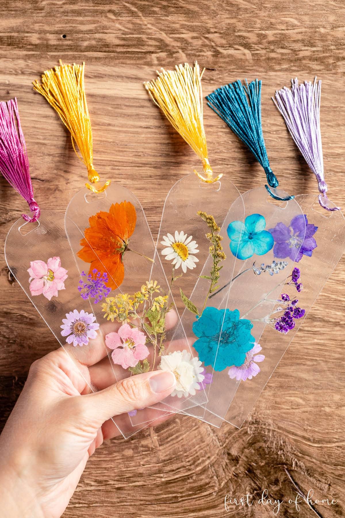 Clear plastic bookmarks with colorful pressed flowers and colorful tassels